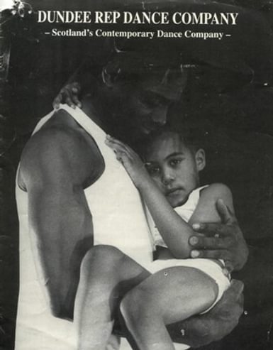 A black man holds his little boy in his arms, both wearing white clothes in black and white with Dundee Rep Dance Company overlaid in white