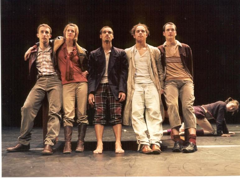 5 dancer stand leaning on one another