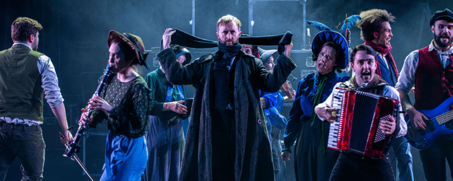 The cast of A Christmas Carol mid-song