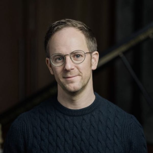 Image of Gareth Williams, a man with glasses wearing a dark blue jumper.