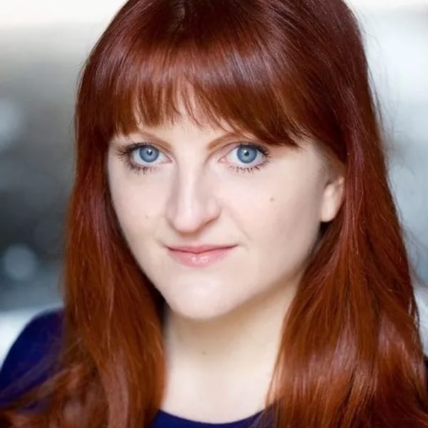 Headshot of Morna Young, a woman with red shoulder length hair and blue eyes